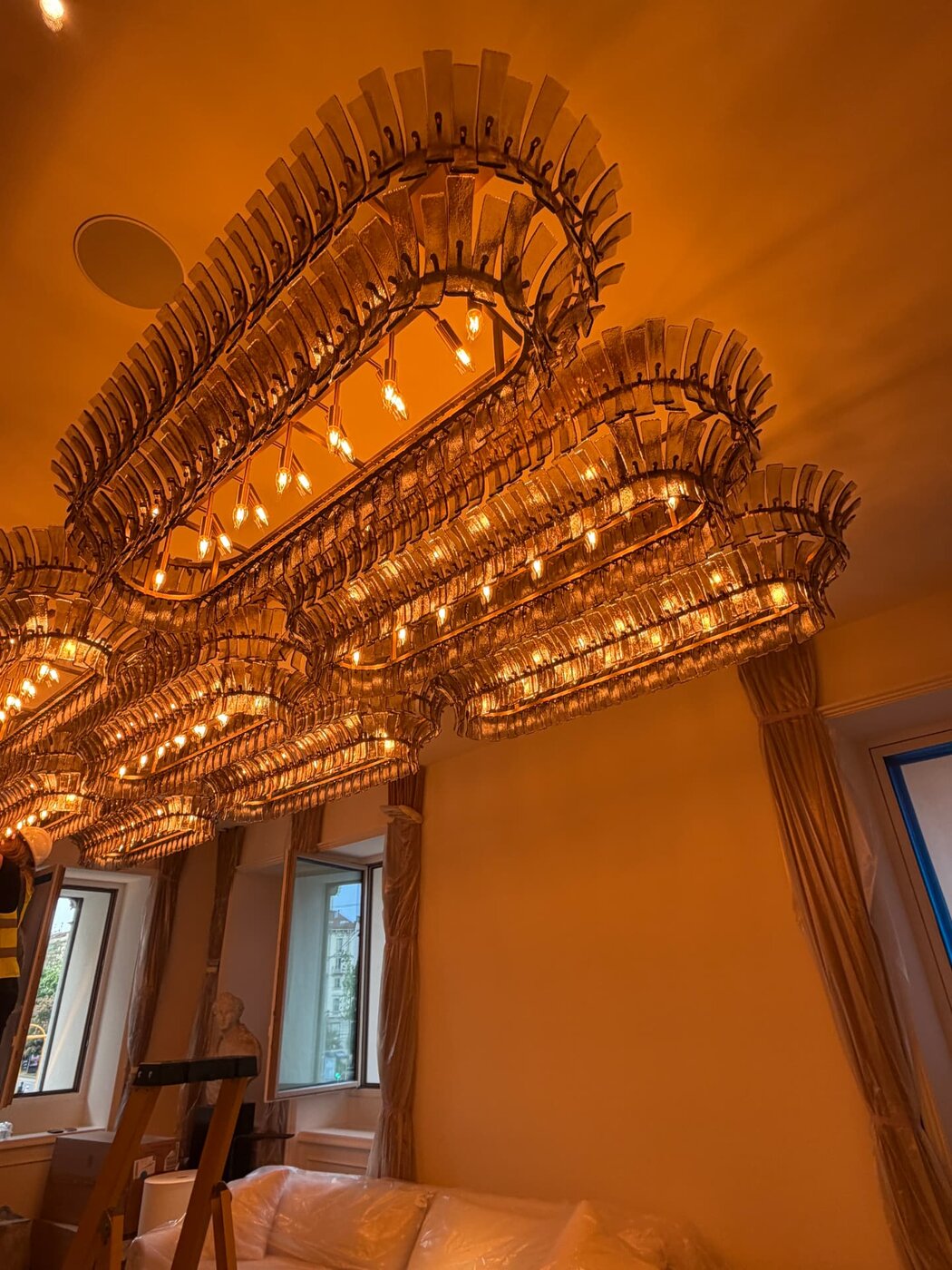 Large decorative chandelier installation in a dining room