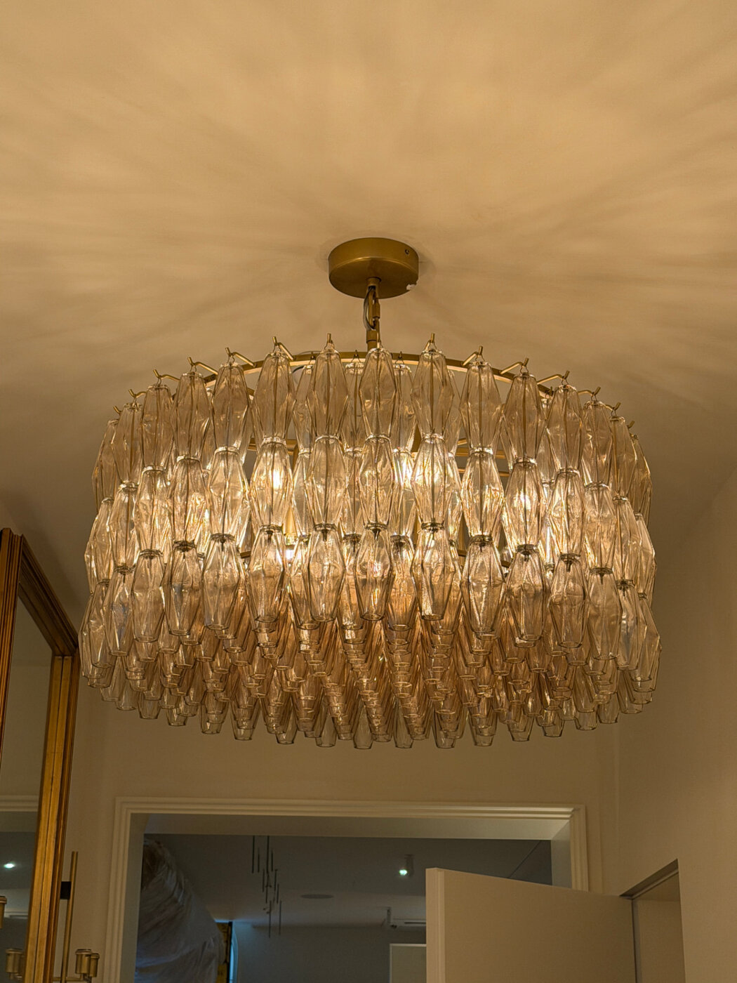 Glass chandelier hung in an entryway